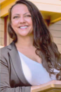 Lucy Petry, a professional real estate agent at Hall and Sellers International Realty Services, smiling in a professional headshot